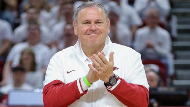Arkansas Razorbacks football coach Sam Pittman introduced with new coaching staff at Kentucky basketball game.